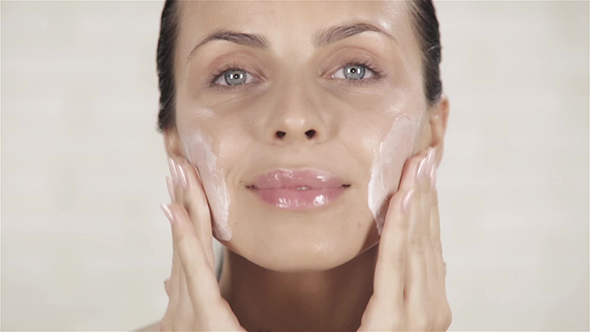 Young Woman Applying Face Cream, Stock Footage | VideoHive