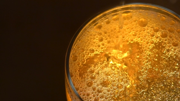 Glass Of Beer With Bubbles On Dark Backround 