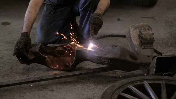 Workman Cuts Iron Details Via Plasma Cutter alt