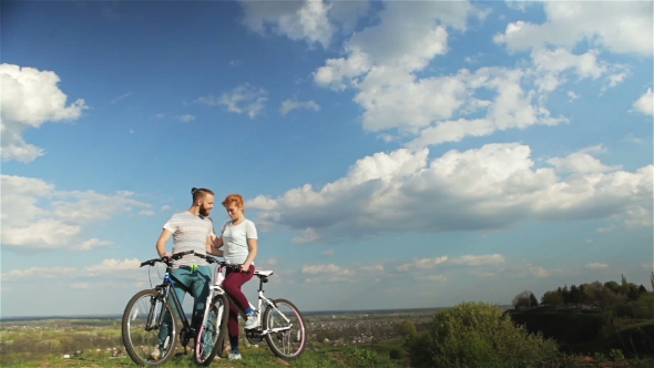 Man and Woman With Bicycles. alt