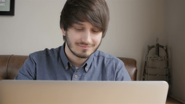 Smiling Casual Student Working On Laptop Computer In Cafe alt