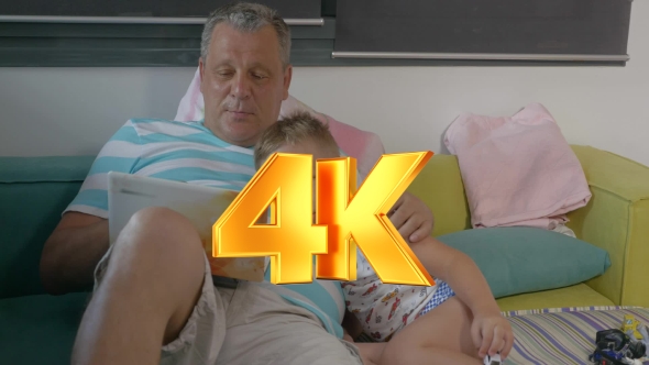 Grandfather and Grandchild With Laptop at Home alt