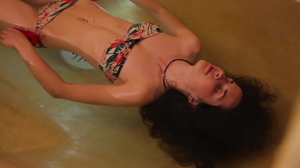 Brunette Girl Relaxing In The Water Spa