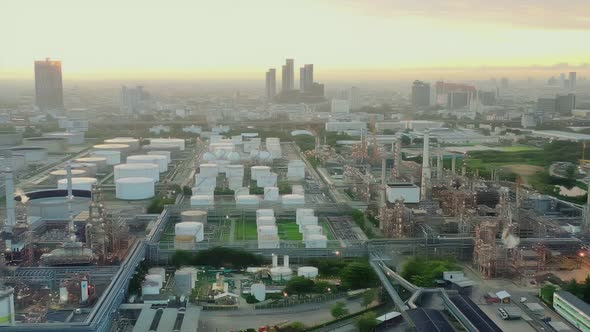 4k aerial view drone of refinery oil petroleum production factory with river reflecting surface alt