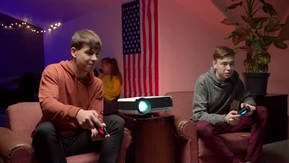 Cheerful Gamers with Joysticks Playing Video Game