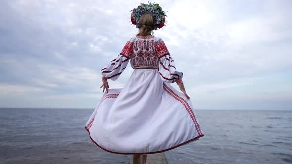 Live Camera Follows Slim Barefoot Ukrainian Woman in National Dress Walking in Slow Motion on River alt