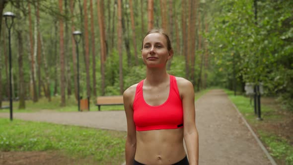 Young Woman Runs Through a Colorful Autumn Forest  She is Doing Her Running Workout Outdoor alt