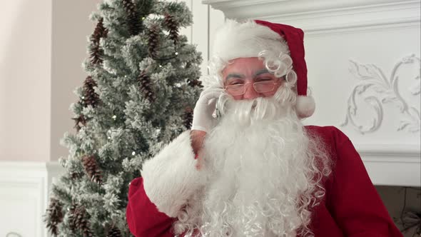 Santa Claus Talking Over the Phone Wishing Merry Christmas
