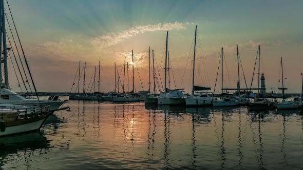 Yachts Moored At Marina In a Row Under The Sunrise