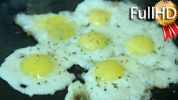 Putting Cracked Eggs on Frying Pan For Breakfast