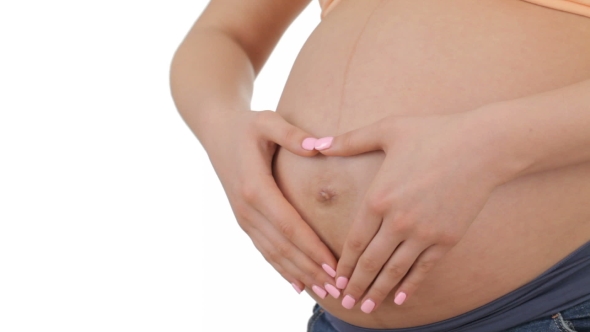 Pregnant Woman Slides Hands Over Her Tummy alt