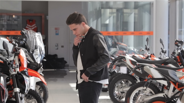 Man Choose The Motorbike At Dealership alt