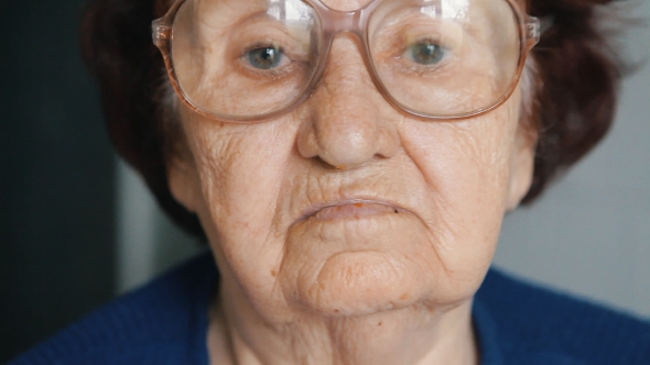  Portrait Of An Old Woman Putting On Glasses alt
