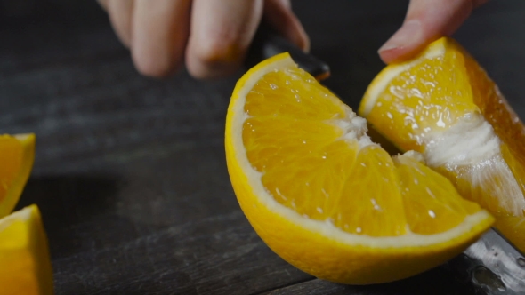 Chef Cut Orange Fruit On Dark Wooden Table alt