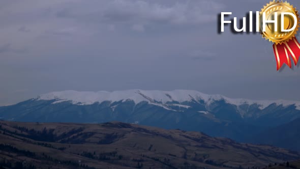 Clouds Moving Across a Snowy Mountains Landscape