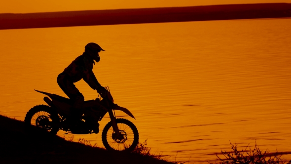 Motorcyclist Silhouette at Sunset alt