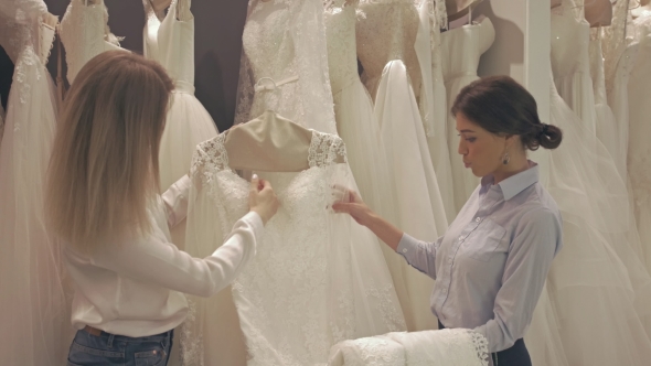 Smiling Pretty Group Of Brides Chooses White Dress At Shop Of Wedding Fashion alt