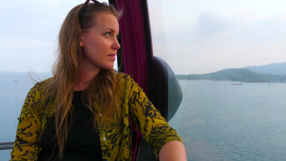 Caucasian Woman Looking On The Sea Bay At Sunset Time From The Cabin