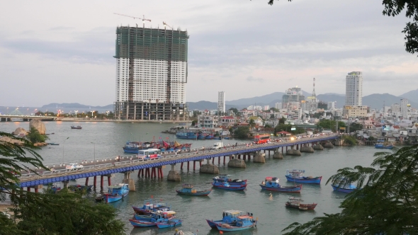 City Bay With Blue Boats And Buildings. Nha Trang, Vietnam.  alt