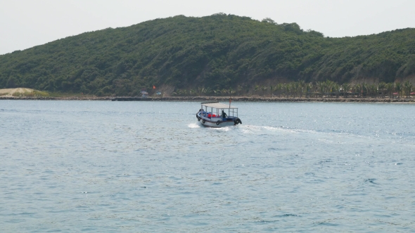 Small Blue Motorboat With Single Person Aboard In See Bay In Vietnam alt