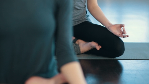 Young Women Meditating Indoors alt