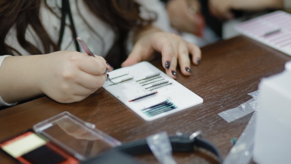 Female Lashmaker Work On Tablet alt
