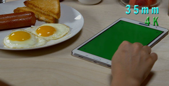Woman Using Tablet With Green Screen At Breakfast 08