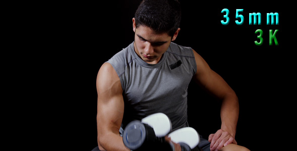Young Man Doing Curls With Dumbbells 29