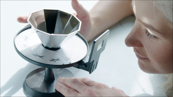 Girl Looking At Cinematograph And Using It alt