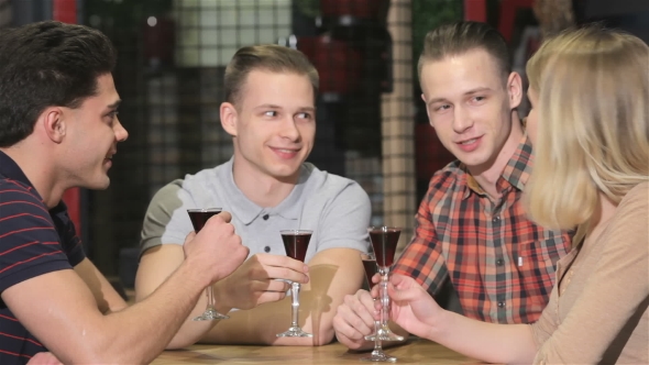 Group Of Young People Drinks Off Liquor At The Restaurant alt