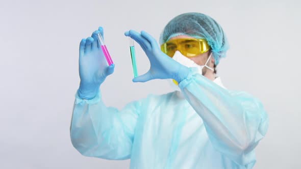 Chemist Holding Test Tubes with Reagents and Compearing Them in ...
