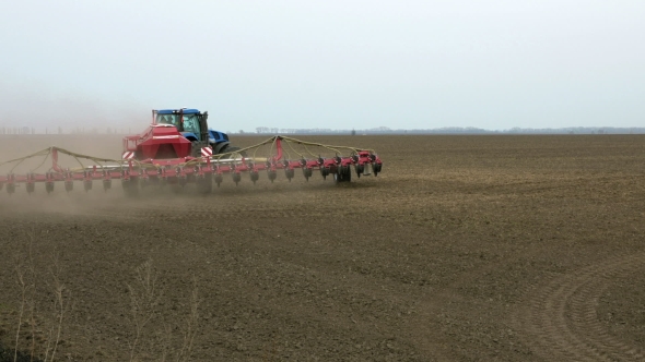 Tractor Ploughs Tills Plows And Seeds On The Field