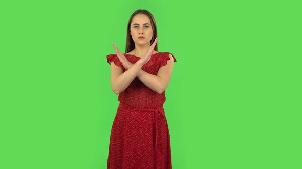 Tender Girl in Red Dress Strictly Gesturing with Hands Crossed Making X Shape Meaning Denial Saying alt