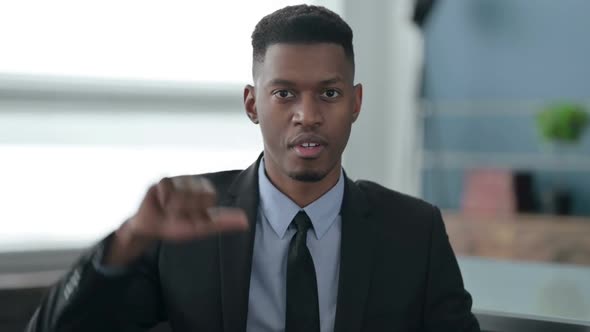 Portrait of African Businessman showing Thumbs Down Gesture alt