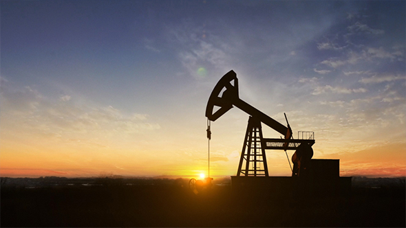 Silhouette Of Crude Oil Pump At Sunset In Oil Field