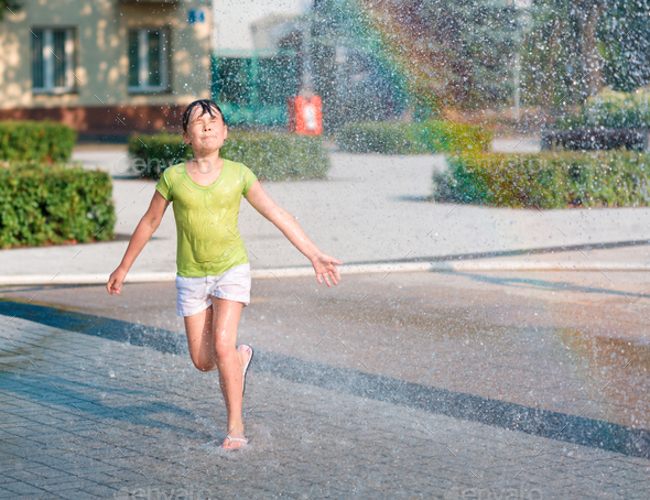 Girl is running through fountains