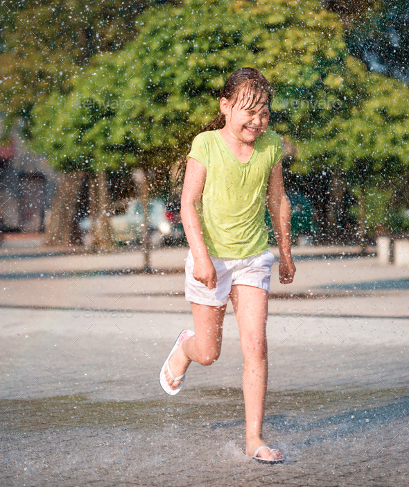 Girl is running through fountains