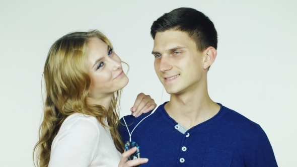 Young Couple Listening To Music On Headphones alt