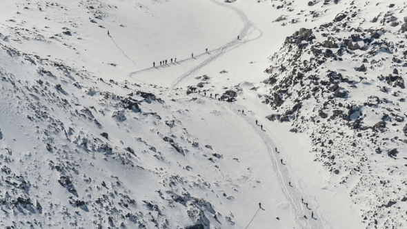 Group Of People Climbing To The Mountain. 