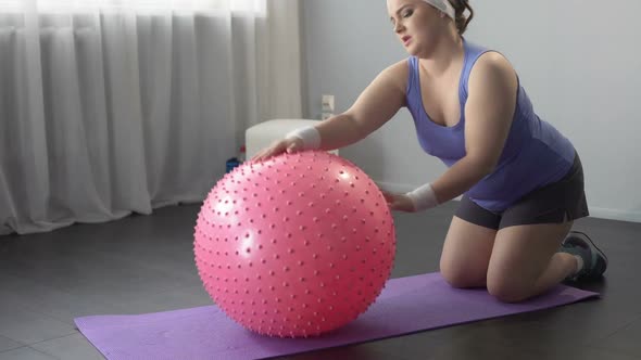 Funny Lazy Girl Lying on Big Fitness Ball, Unable to Do Weight Loss Exercises alt
