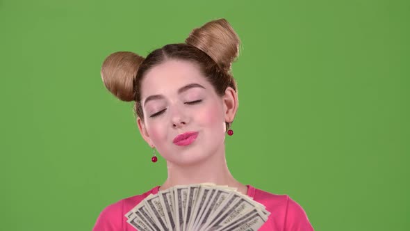 Teen Sniffs Paper Bills and She Is Delighted. Green Screen. Close Up. Slow Motion alt