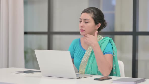 Indian Woman Thinking While Working on Laptop in Office alt