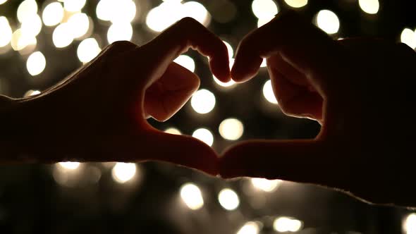 Couple Hands With Love Symbol On Bokeh Lights Background alt