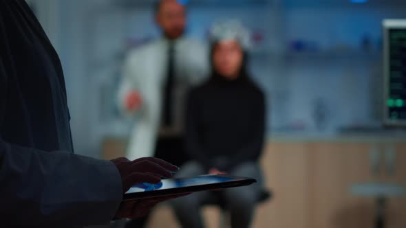 Close Up of Scientist in Neurological Dysfunctions Working at Tablet alt