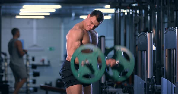 Bodybuilder Doing an Exercise with a Barbell in the Gym alt