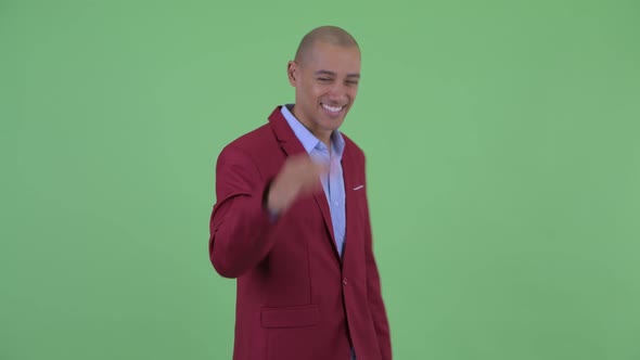 Happy Bald Multi Ethnic Businessman with Ok Sign alt