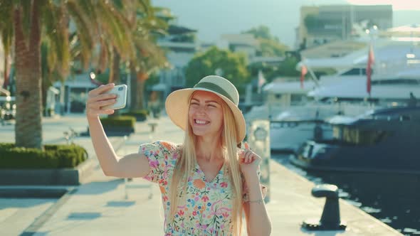Pretty Girl in Sun Hat Making Selfie on Smartphone