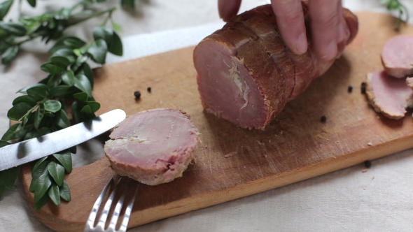 Man Is Cutting Slice Of Smoked Ham alt