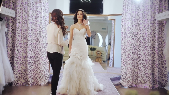 Designer Wedding Salon Measures a Young Girl To Choose Dress Size alt