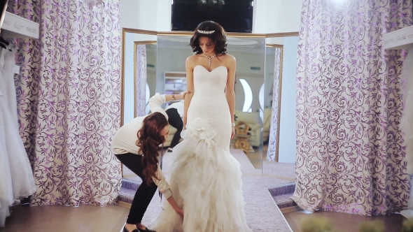 Designer Wedding Salon Measures a Young Girl To Choose Dress Size alt